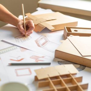 Designer,Draws,A,Mockup,For,Crafting,Cardboard,Box.,Development,Of Designer,Draws,A,Mockup,For,Crafting,Cardboard,Box.,Development,Of